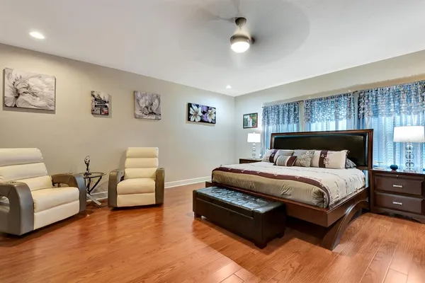 a front view of a house with garden and plants