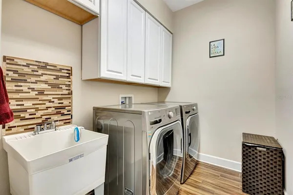 a kitchen with kitchen island granite countertop a sink and cabinets