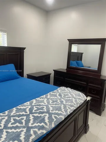 a bedroom with a bed and hallway