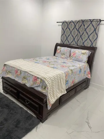 a bedroom with a bed and a chair