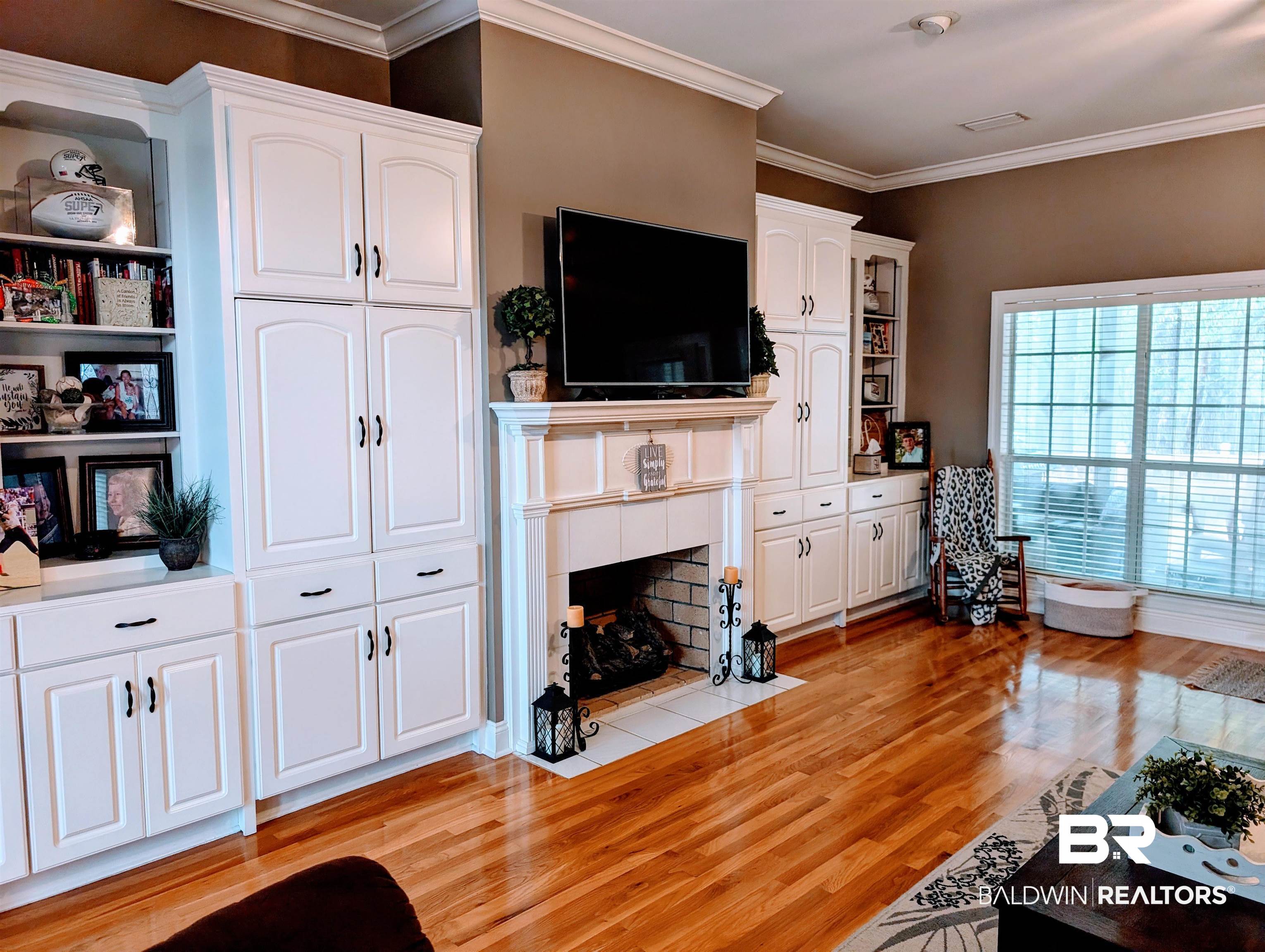 506 Old Castleberry Road Brewton, AL 36426 - Photo 4 of 14 Living room with a tiled fireplace, light wood-style floors, and ornamental molding