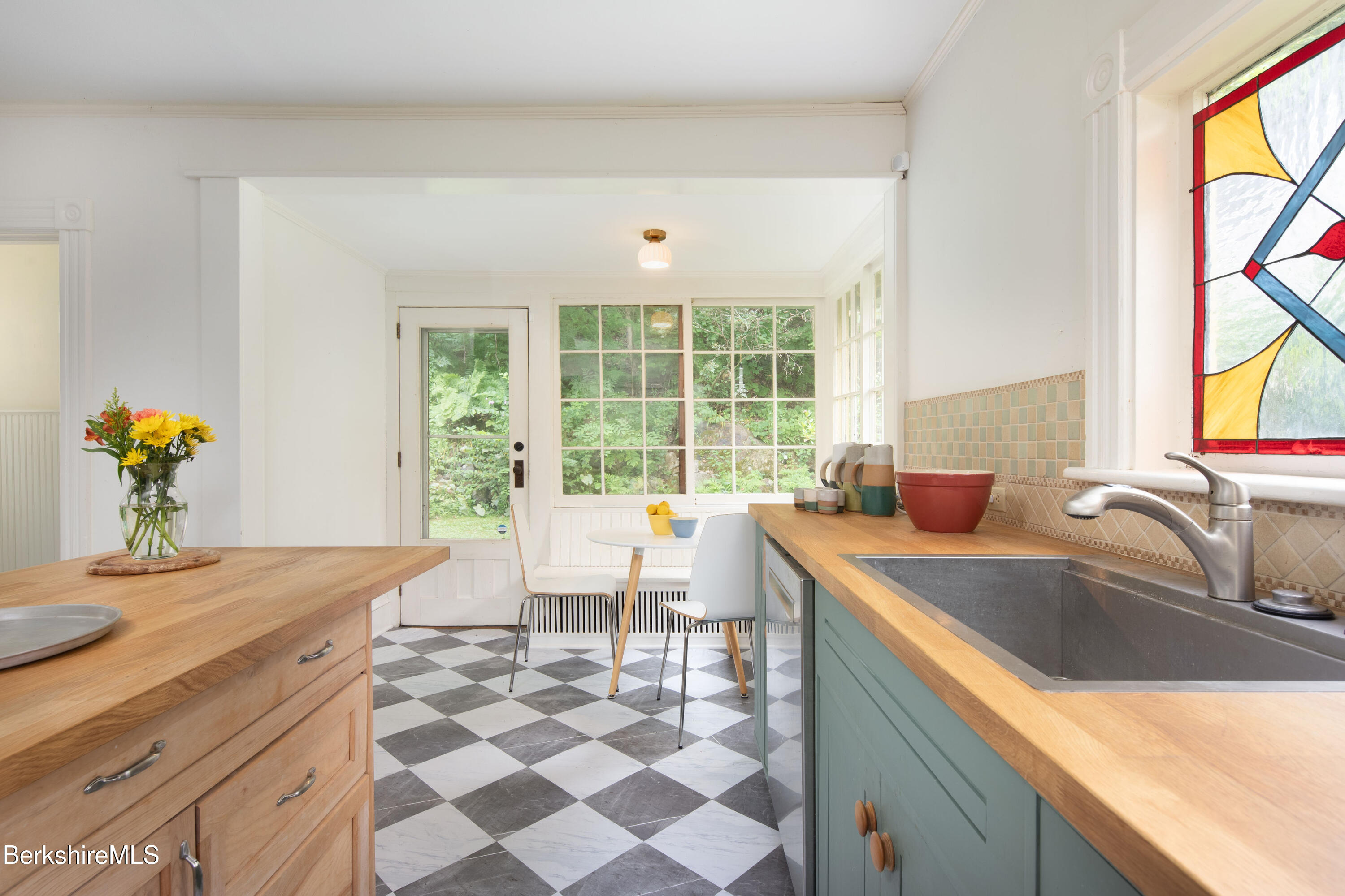 77 Grove Street Great Barrington, MA 01230 - Photo 16 of 31 a kitchen with a sink a counter top space and living room filled with furniture
