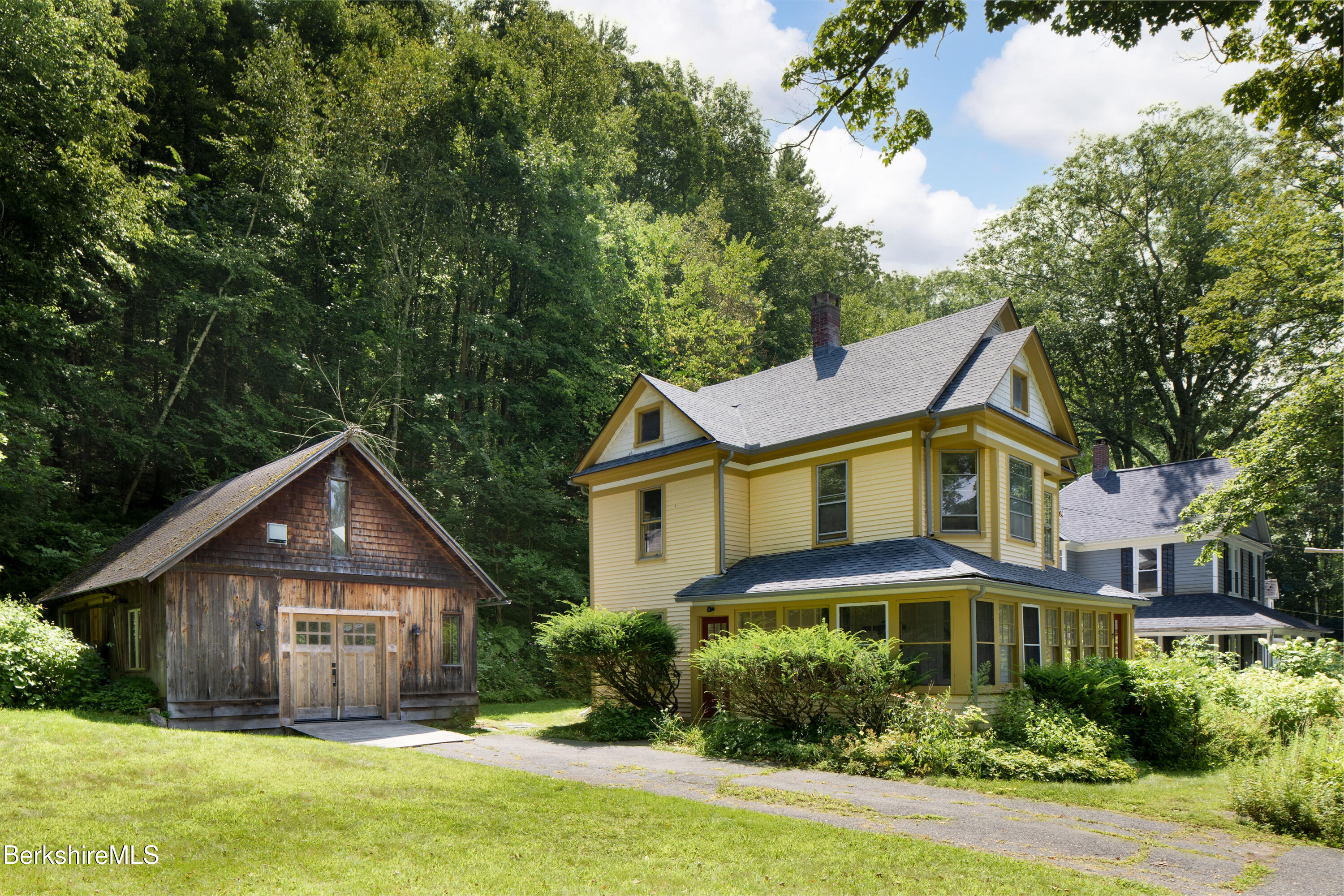 77 Grove Street Great Barrington, MA 01230 - Photo 2 of 31 a front view of a house with a yard and potted plants