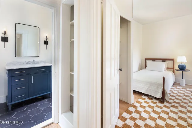 a bedroom with a bed and a mirror