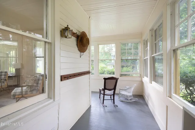 a view of a hallway with wooden floor and glass door