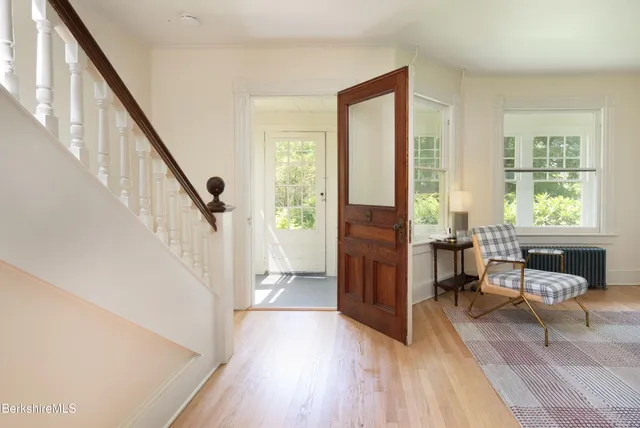 a living room with furniture and large windows