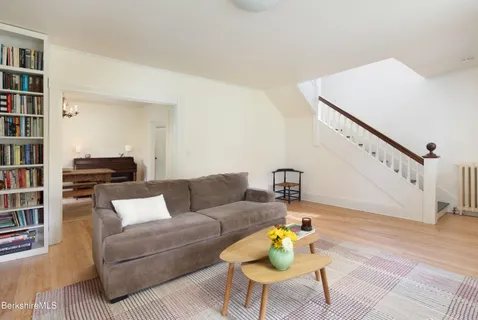 a living room with furniture and a book shelf
