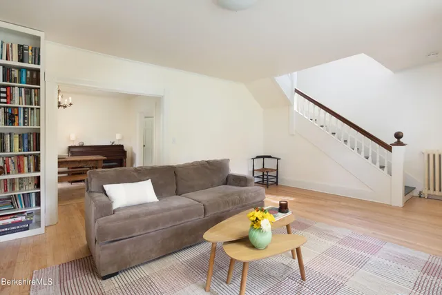 a living room with furniture and a book shelf