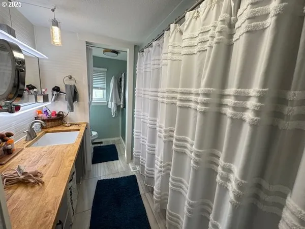 a bedroom with a bed window and a flat screen tv