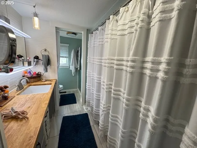 a bedroom with a bed window and a flat screen tv