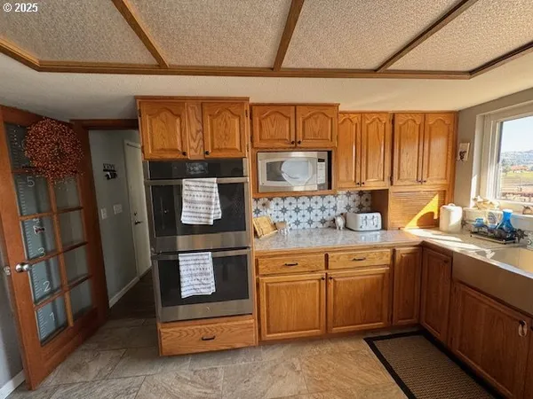 a kitchen with stainless steel appliances a sink stove and cabinets