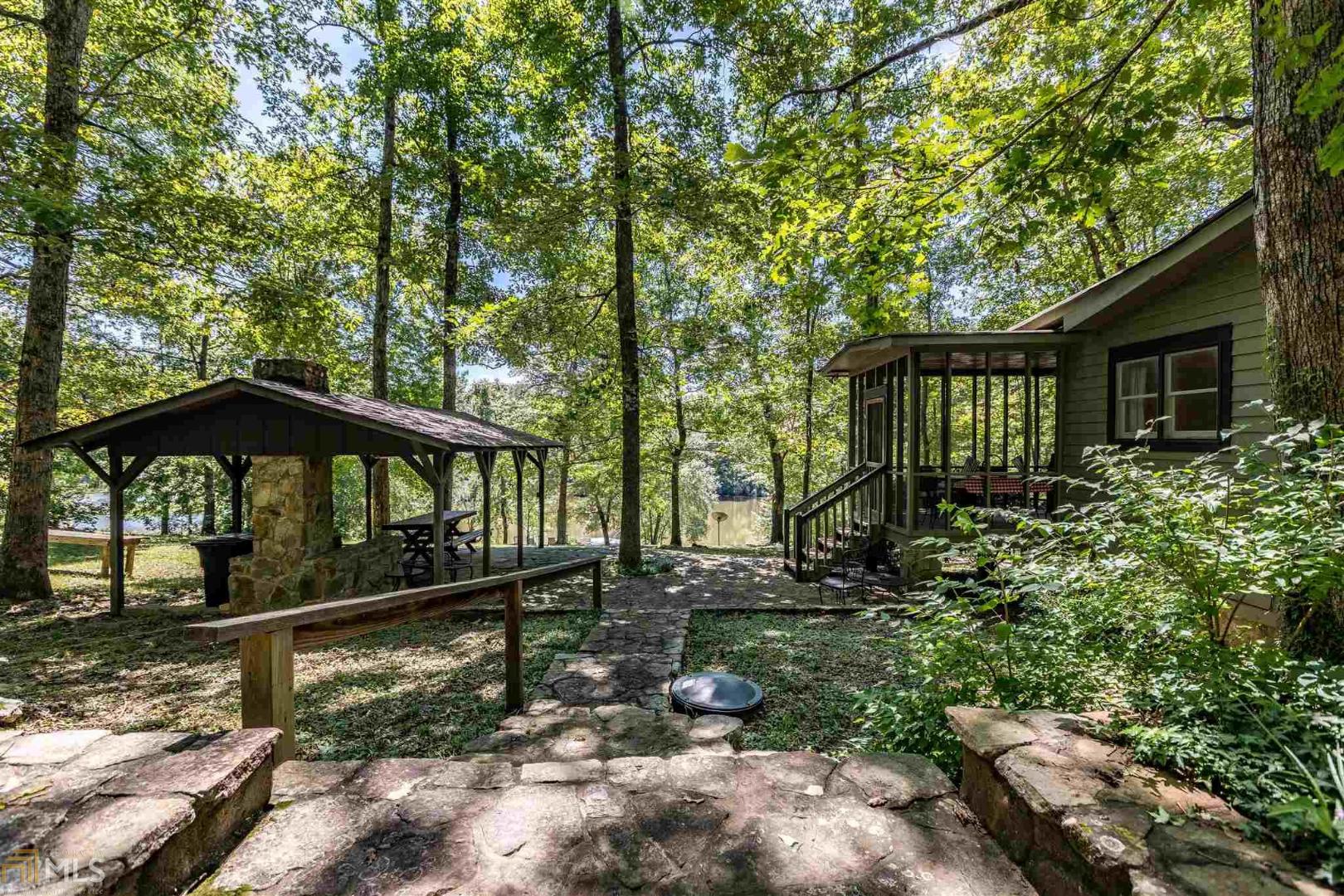 540 County Road Mentone, AL 35984 - Photo 1 of 1 a view of a small yard with large trees and plants