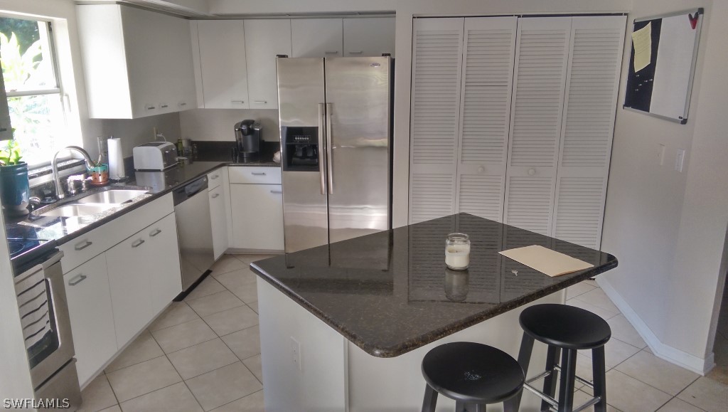 17501 Butler Road Fort Myers, FL 33967 - Photo 15 of 20 a kitchen with stainless steel appliances granite countertop a sink a refrigerator and a stove