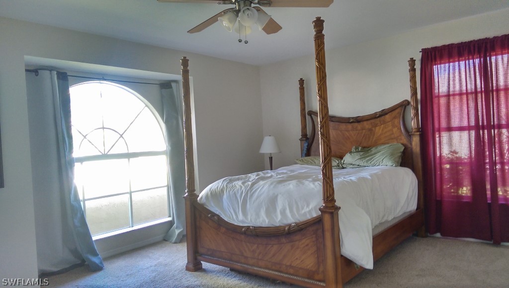 17501 Butler Road Fort Myers, FL 33967 - Photo 17 of 20 a bed sitting in a bedroom next to a window