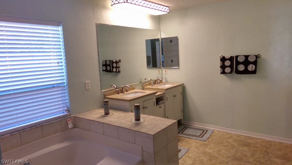 17501 Butler Road Fort Myers, FL 33967 - Photo 18 of 20 a bathroom with a sink a toilet and mirror