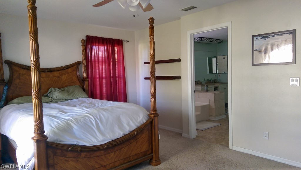 17501 Butler Road Fort Myers, FL 33967 - Photo 19 of 20 a bed room with a bed and mirror