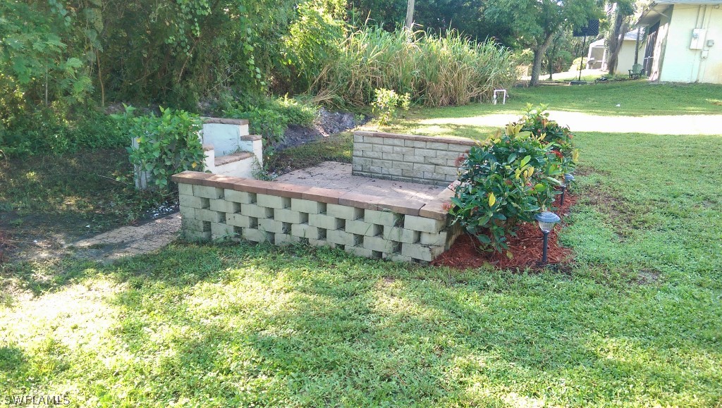 17501 Butler Road Fort Myers, FL 33967 - Photo 8 of 20 a view of a garden with a bench