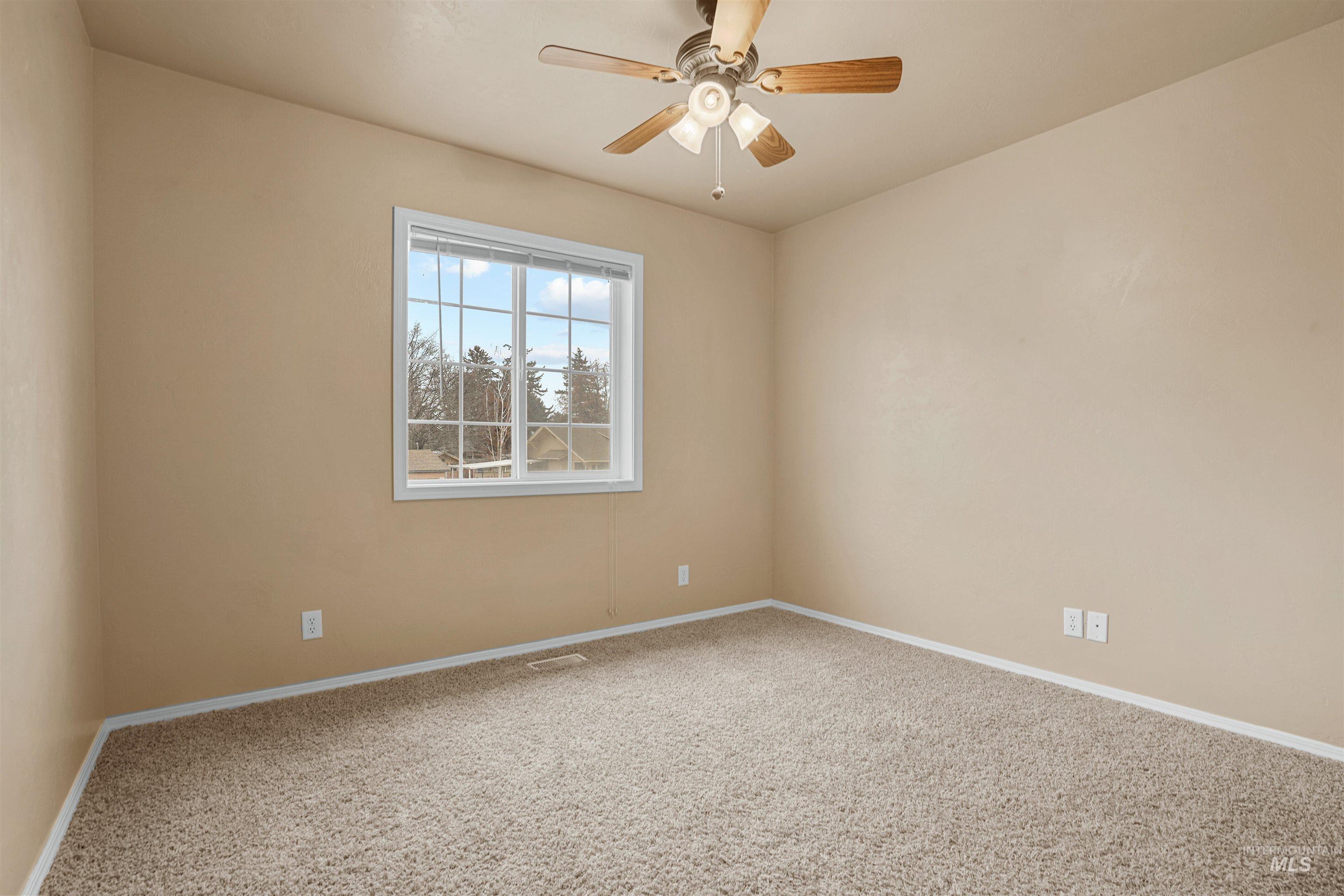 720 East Main Street Jerome, ID 83338 - Photo 15 of 50 Carpeted empty room featuring ceiling fan and baseboards