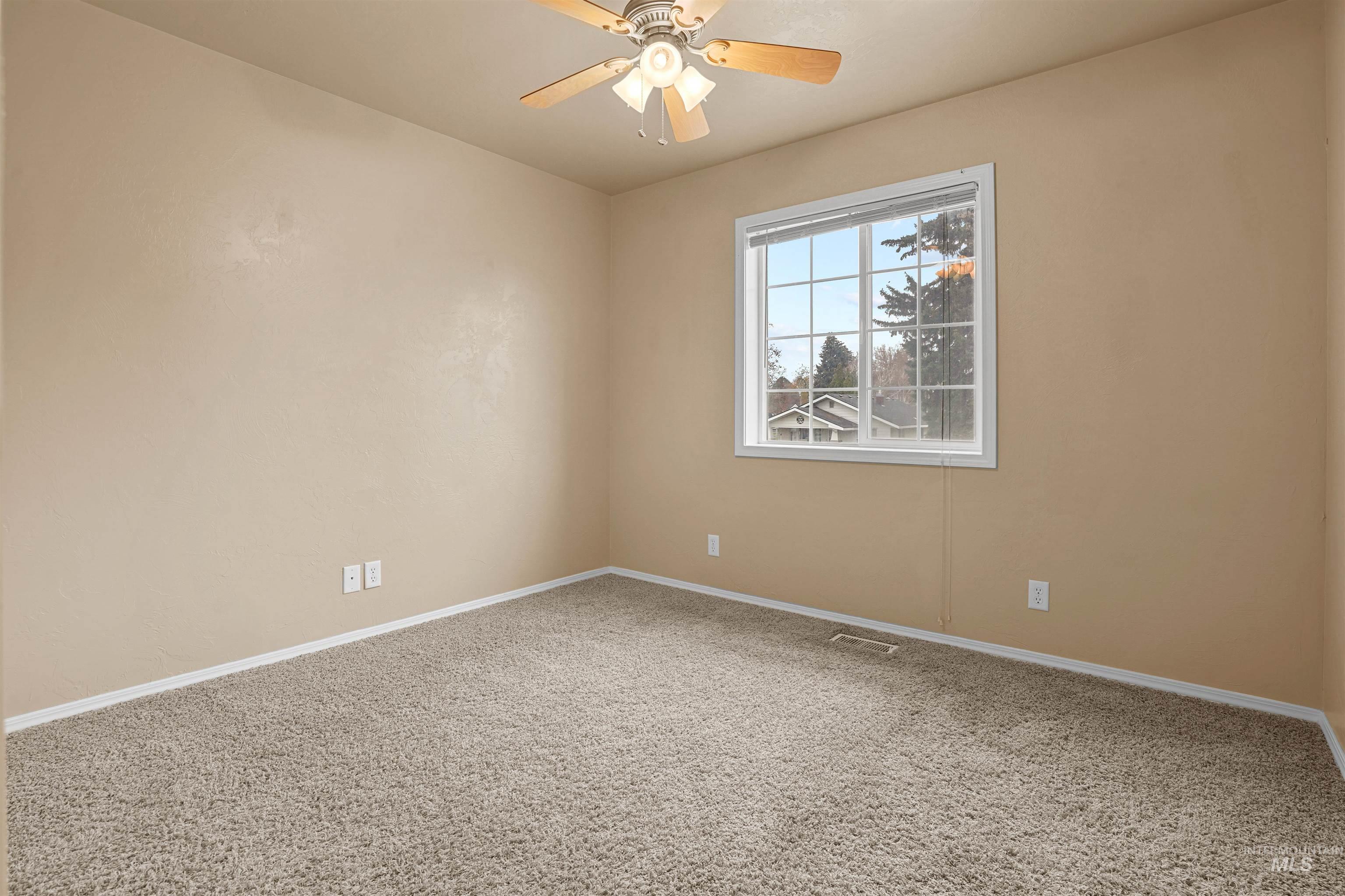 720 East Main Street Jerome, ID 83338 - Photo 17 of 50 Empty room with carpet flooring and ceiling fan