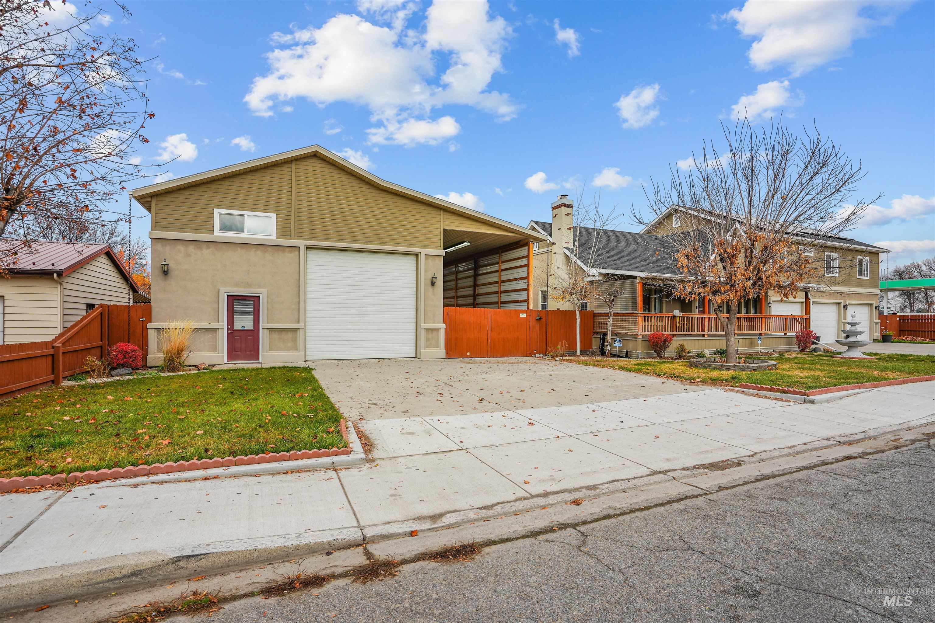 720 East Main Street Jerome, ID 83338 - Photo 28 of 50 View of front facade featuring driveway, a garage, and a chimney