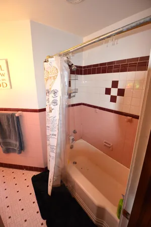 a bathroom with a bathtub and shower