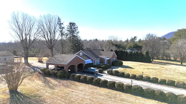 a view of a house with a yard covered in snow