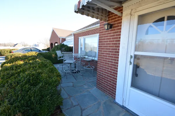a view of large white house with a yard