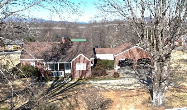 a view of a house with a yard covered in snow