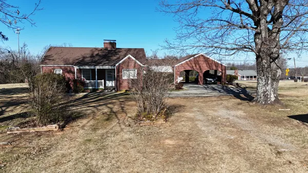 a view of a house with a yard covered in snow