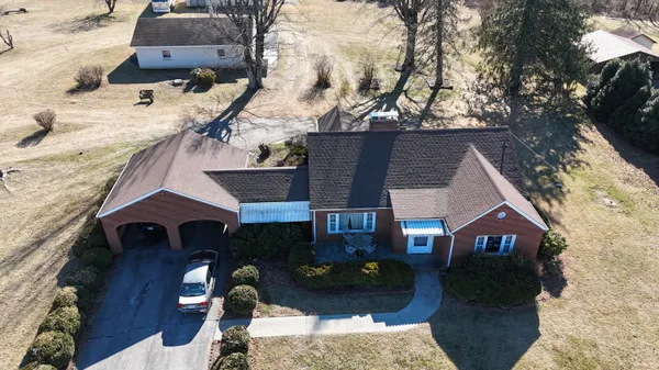 an aerial view of a house with a yard