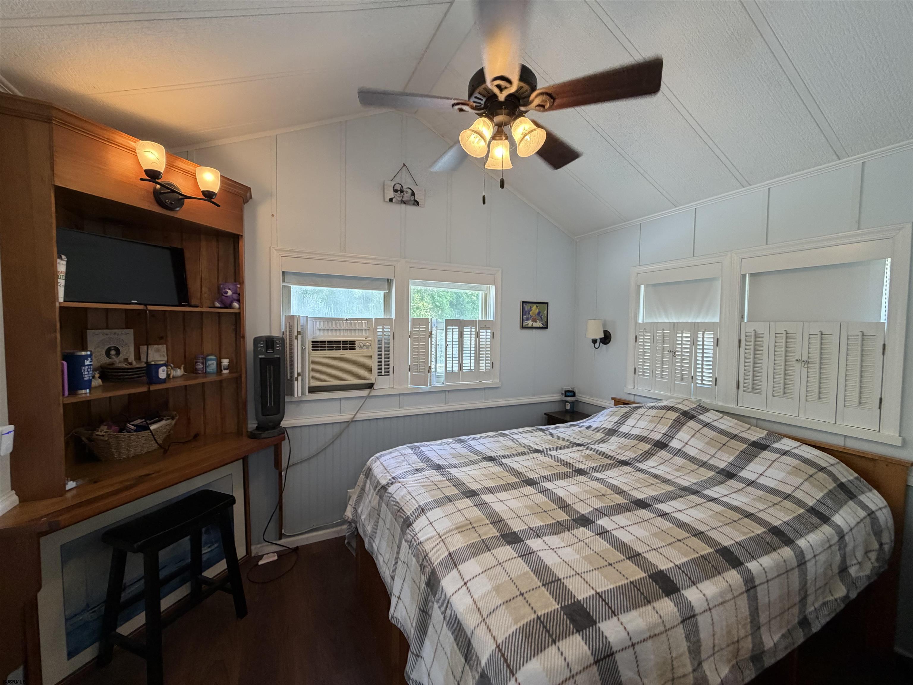 631 Chestnut Neck Road Port Republic, NJ 08241 - Photo 2 of 13 a bedroom with a bed and a chandelier