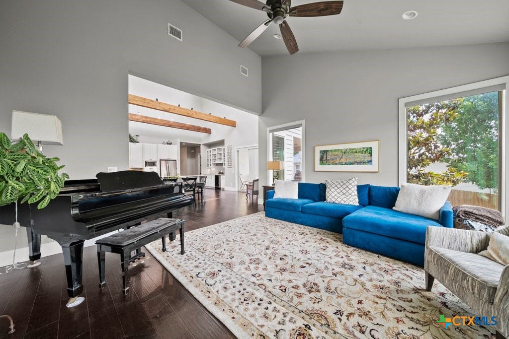 1165 Turtle Trail New Braunfels, TX 78130 - Photo 14 of 48 a living room with furniture and a piano next to a large window