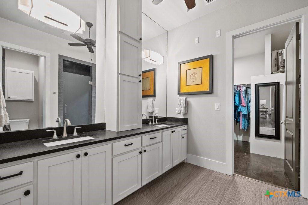 1165 Turtle Trail New Braunfels, TX 78130 - Photo 17 of 48 a hallway with sink and mirror