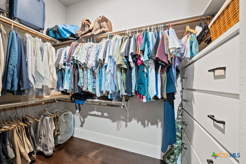 1165 Turtle Trail New Braunfels, TX 78130 - Photo 21 of 48 a view of walk in closet with clothes and shoes