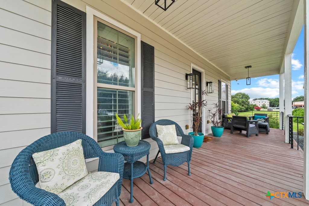 1165 Turtle Trail New Braunfels, TX 78130 - Photo 3 of 48 a balcony with furniture and wooden floor