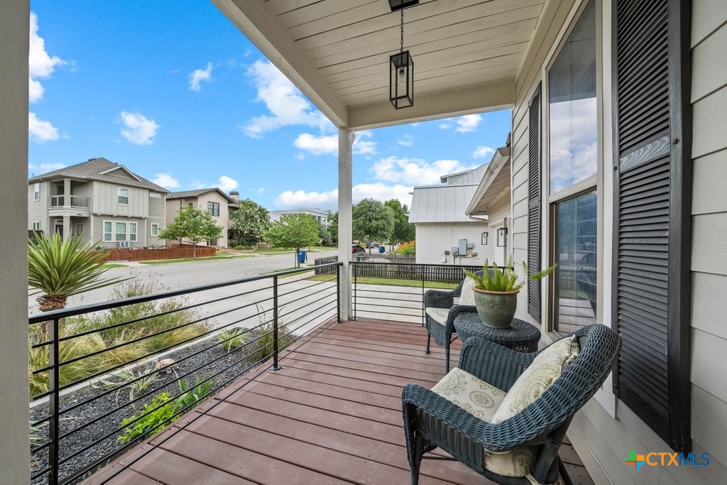 1165 Turtle Trail New Braunfels, TX 78130 - Photo 3 of 48 a view of a patio with couches table and chairs with wooden floor