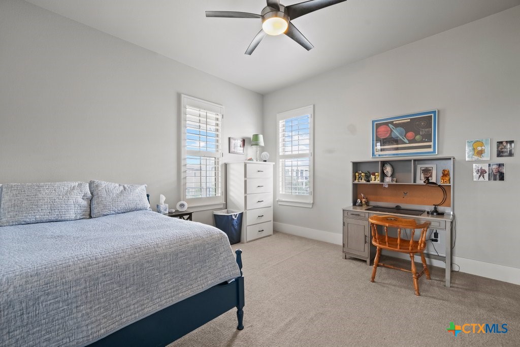 1165 Turtle Trail New Braunfels, TX 78130 - Photo 33 of 48 a bedroom with a large bed a desk and chair