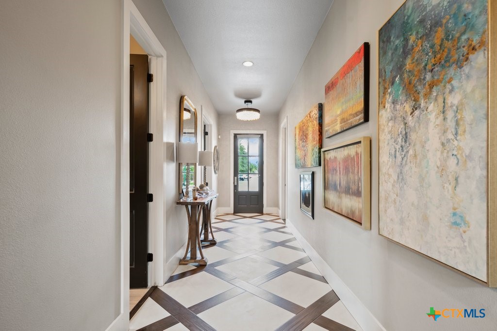 1165 Turtle Trail New Braunfels, TX 78130 - Photo 4 of 48 a view of a hallway with windows