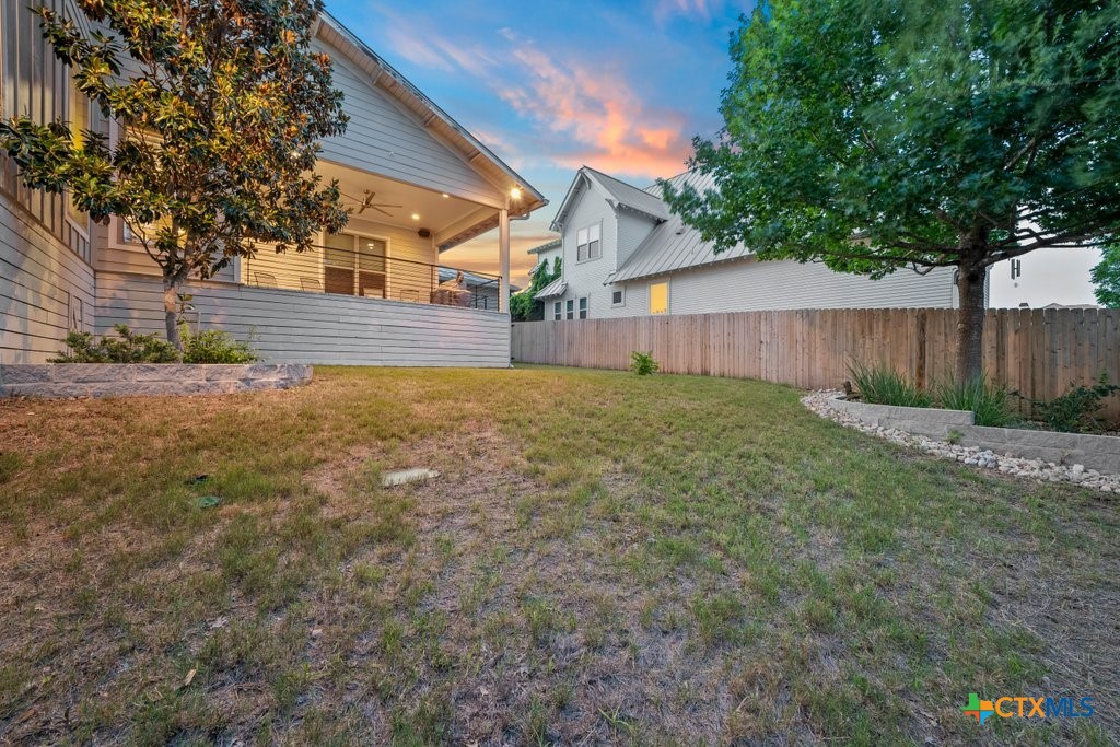 1165 Turtle Trail New Braunfels, TX 78130 - Photo 46 of 48 a view of a yard with plants and a large tree