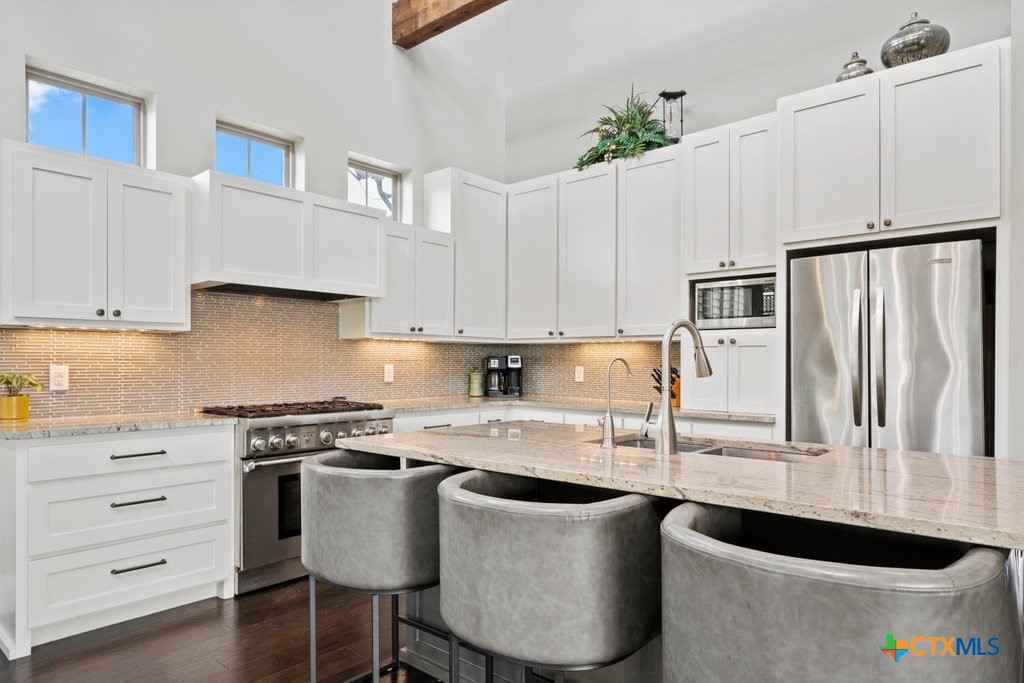 1165 Turtle Trail New Braunfels, TX 78130 - Photo 6 of 48 a kitchen with granite countertop a white cabinets and white appliances