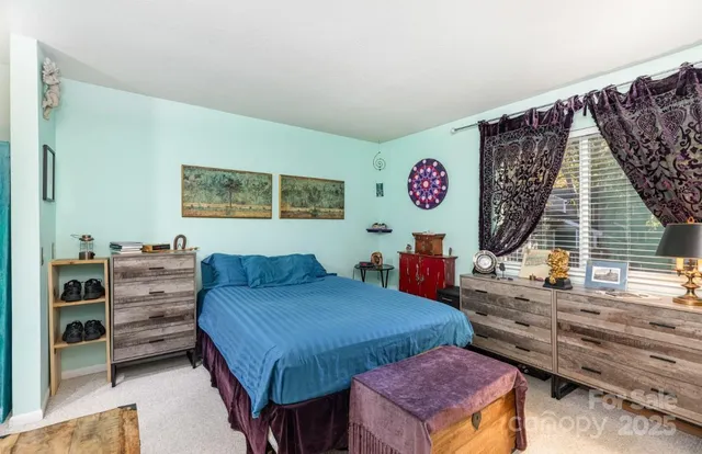 a bed room with a bed and a television