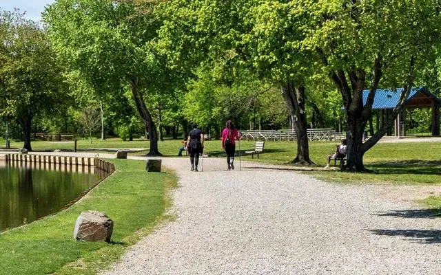 a view of a park with swings and trees