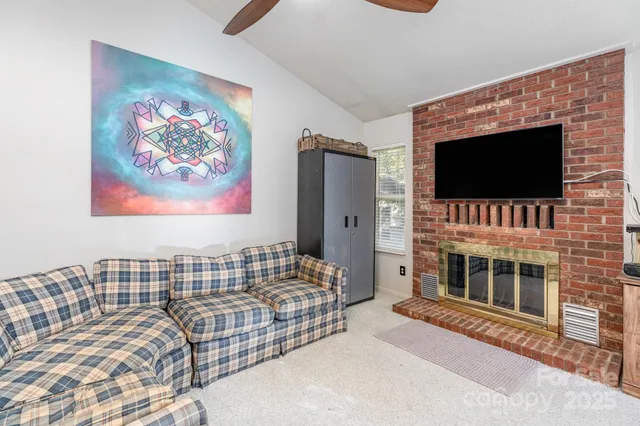 a living room with a flat screen tv and a fireplace