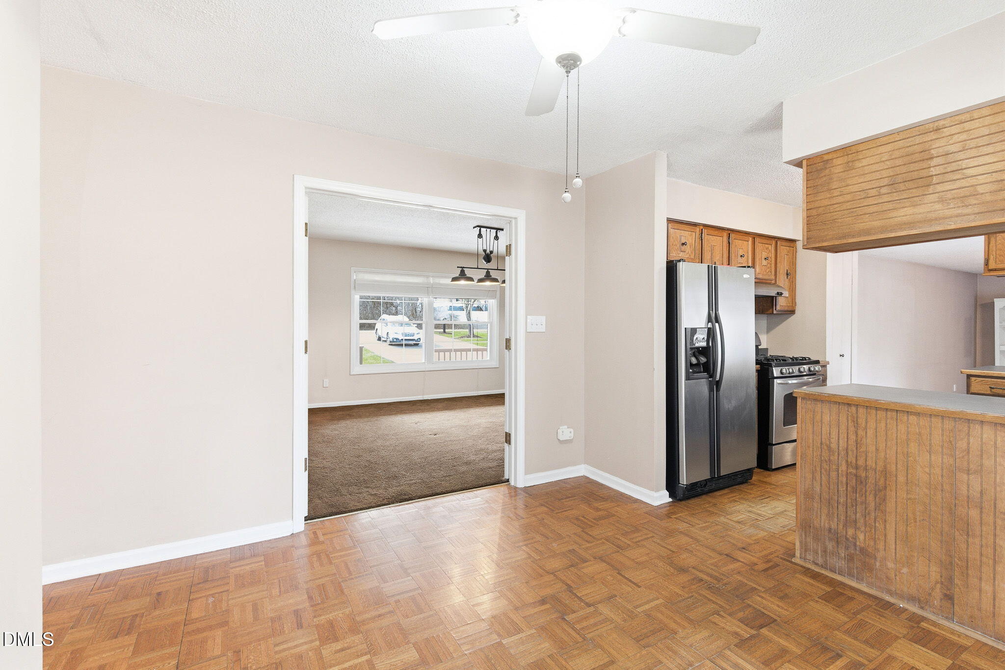 1836 Brier Lane Graham, NC 27253 - Photo 12 of 33 a view of a kitchen with a refrigerator cabinets and a wooden floor