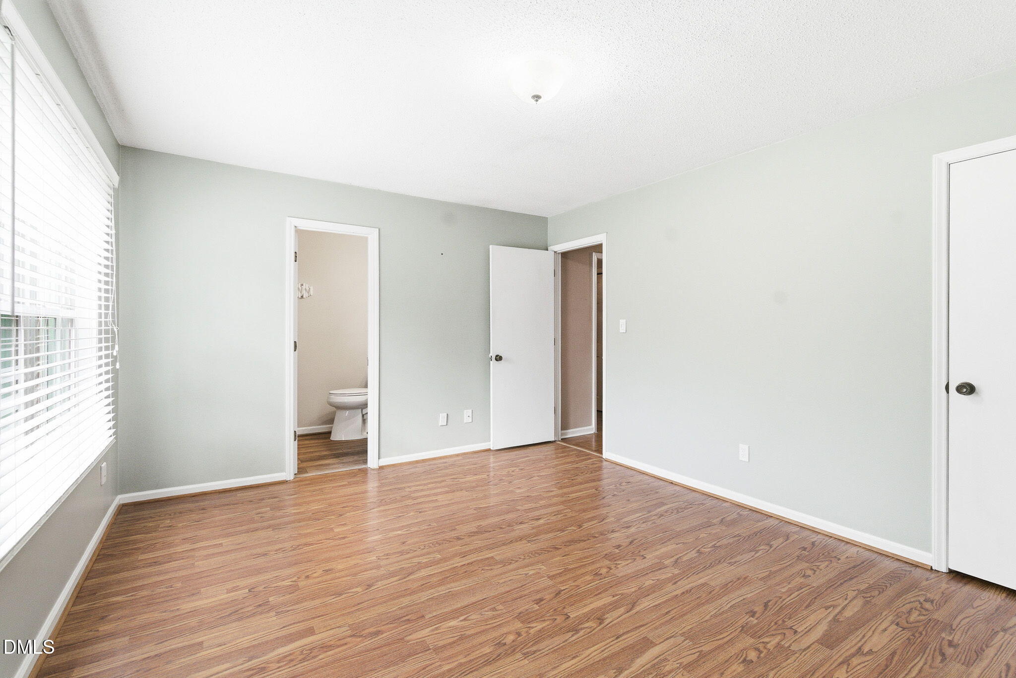 1836 Brier Lane Graham, NC 27253 - Photo 17 of 33 a view of an empty room with wooden floor and a window