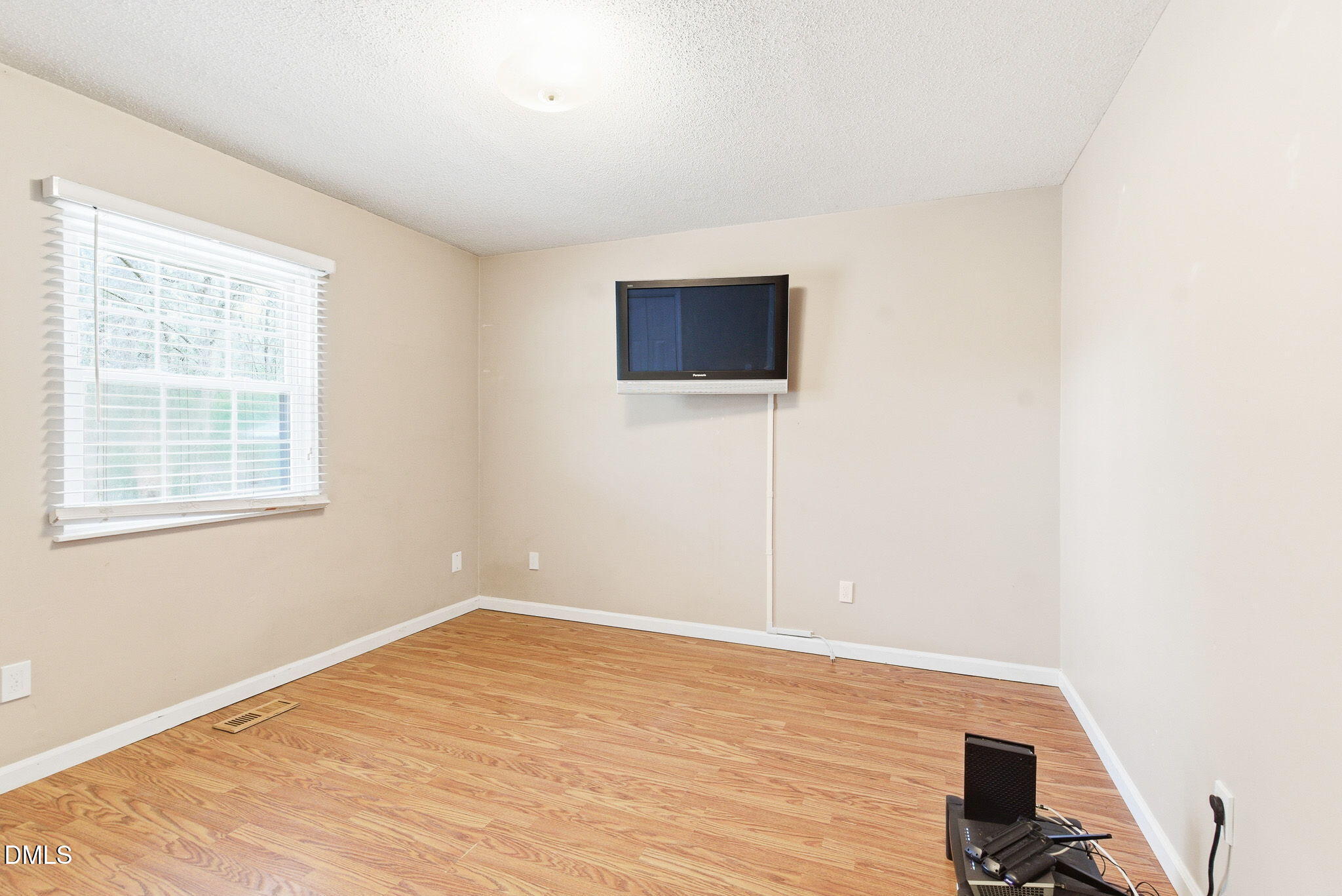 1836 Brier Lane Graham, NC 27253 - Photo 22 of 33 a view of an empty room with wooden floor and a window