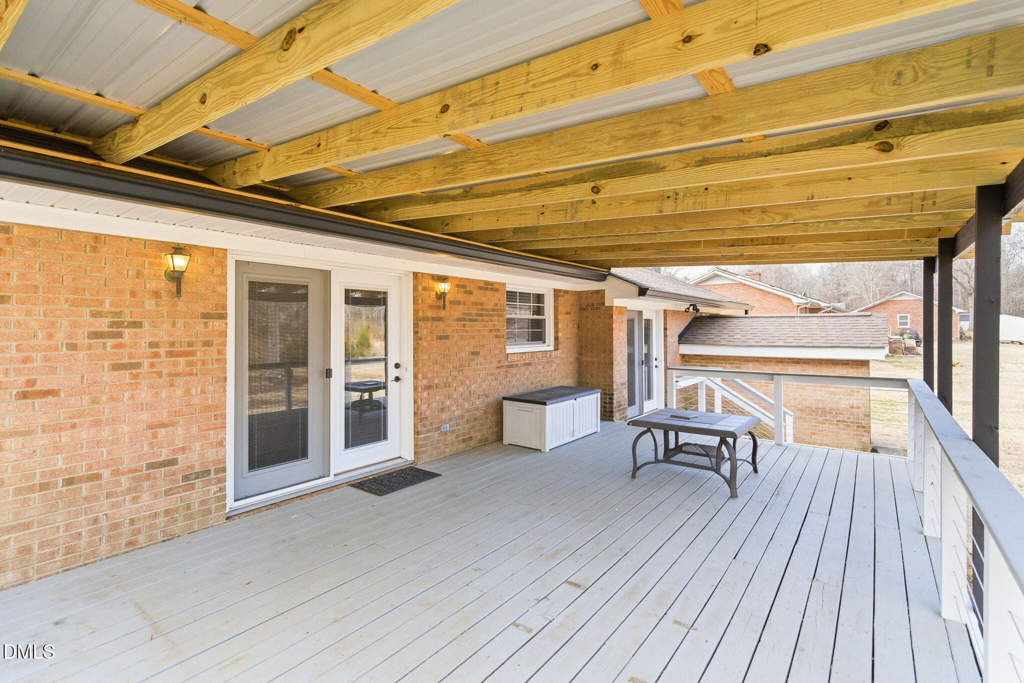 1836 Brier Lane Graham, NC 27253 - Photo 27 of 33 a view of a patio with table and chairs and wooden floor