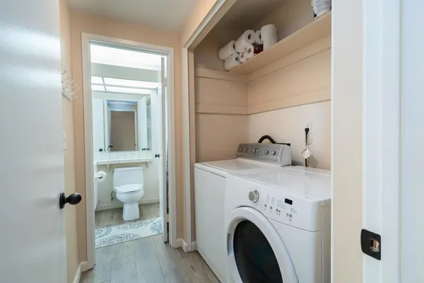a view of bathroom with a toilet a sink and a mirror