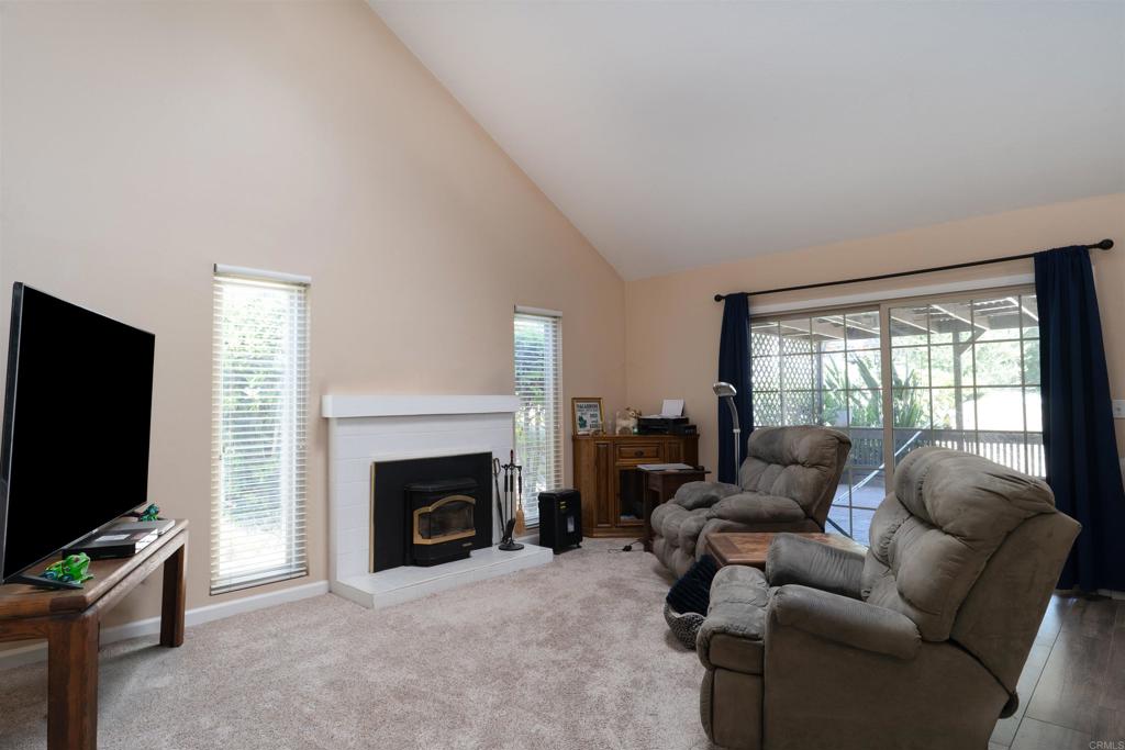 23691 Country Villa Road Ramona, CA 92065 - Photo 7 of 22 a living room with furniture a flat screen tv and a fireplace