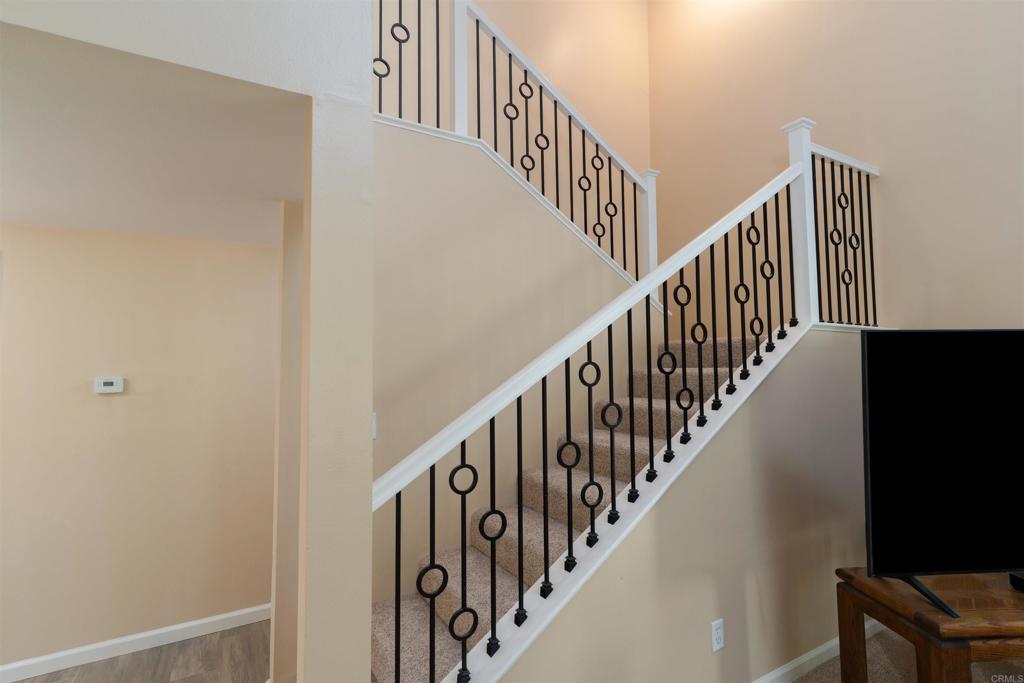 23691 Country Villa Road Ramona, CA 92065 - Photo 9 of 22 a view of staircase with railing and white walls